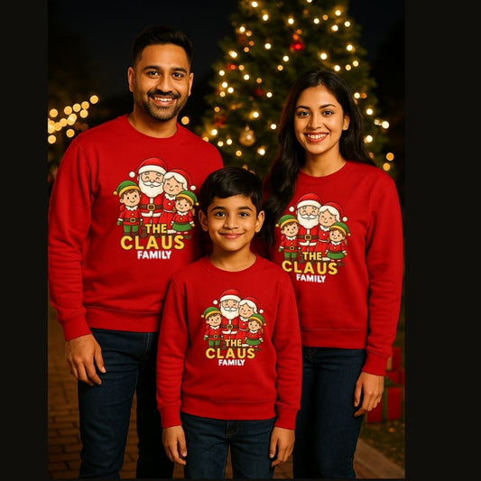 Family of three wearing matching Christmas-themed sweatshirts with 'The Claus Family' design Red