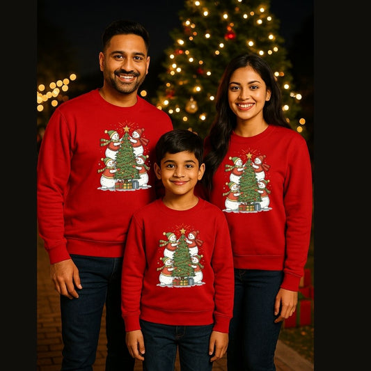 Family of three wearing matching Red Christmas-themed sweatshirts