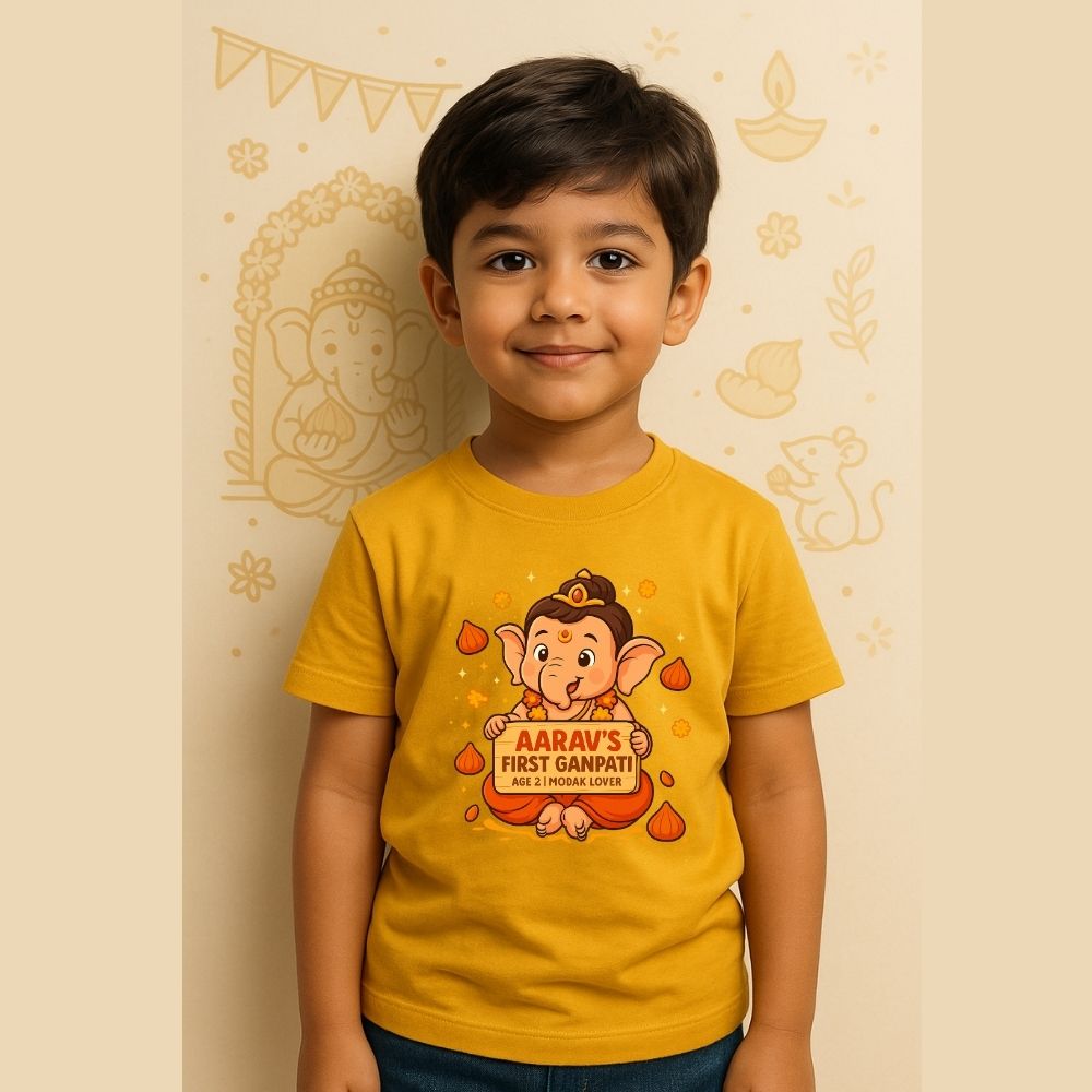 a yellow t-shirt with a cartoon character and text, standing against a decorated wall.