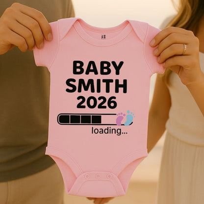 Light Pink baby onesie with 'BABY SMITH 2026 loading...' text and Baby Footprint with Loading Bar Graphic design