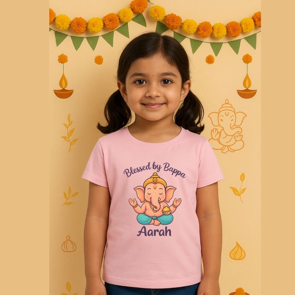 Festive Ganesh Chaturthi T-Shirt Pastelpink t-shirt with a cartoon character and text 