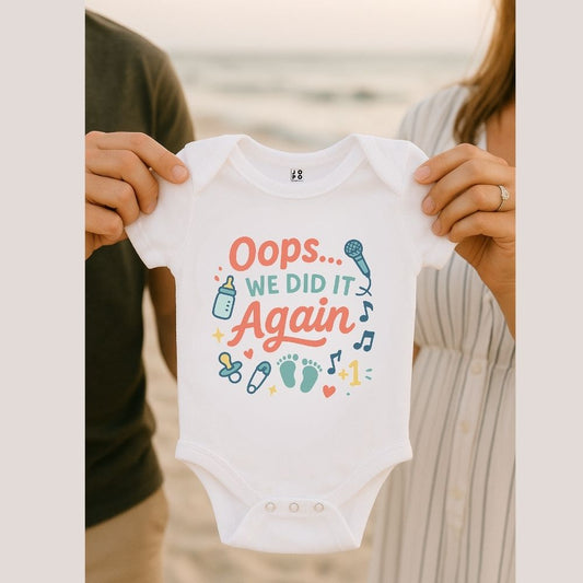 Baby onesie with 'Oops... We Did It Again' text 