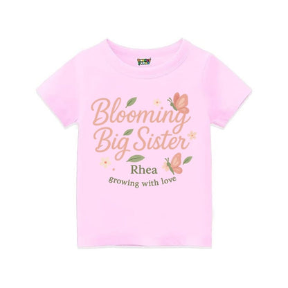 'Blooming Big Sister' and Growing with Love text, with floral and butterfly design printed, Ltpink t-shirt.