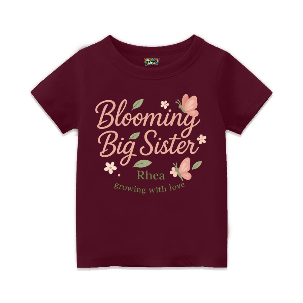 'Blooming Big Sister' and Growing with Love text, with floral and butterfly design printed, Maroon t-shirt.