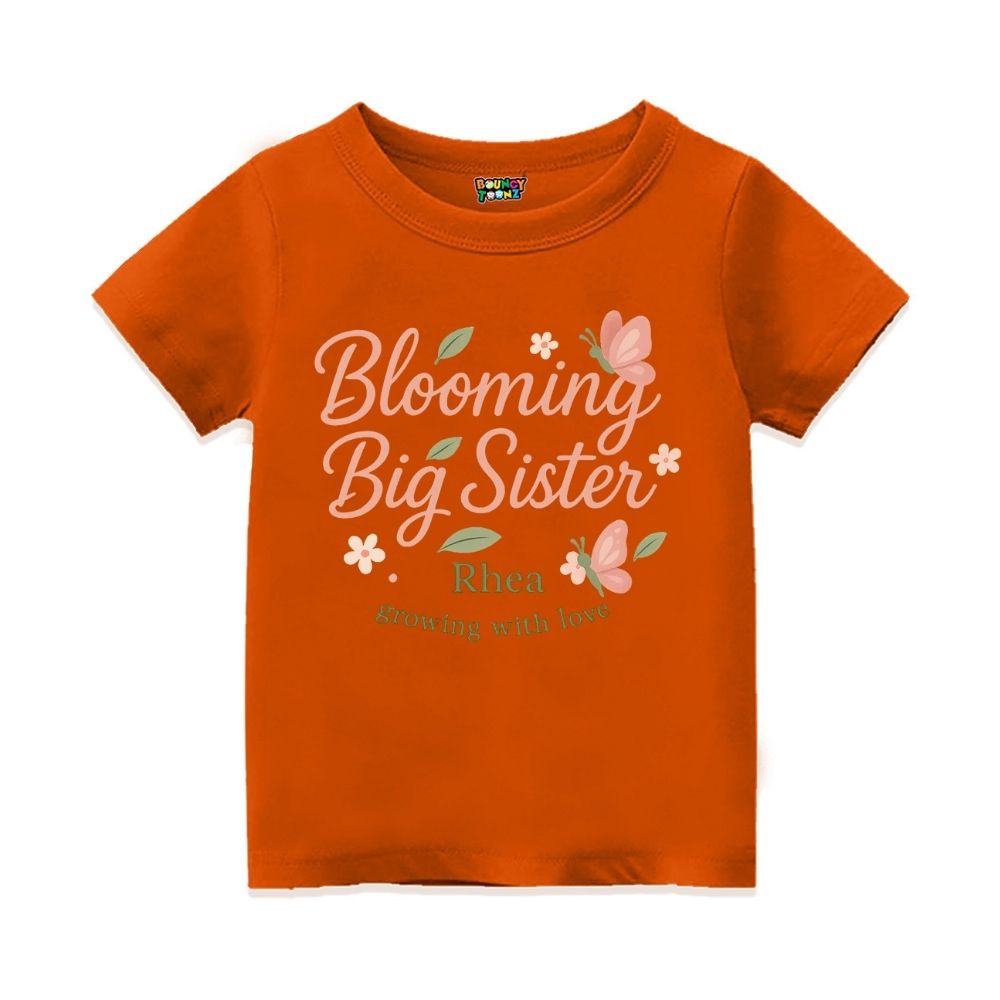 'Blooming Big Sister' and Growing with Love text, with floral and butterfly design printed, Orange t-shirt.