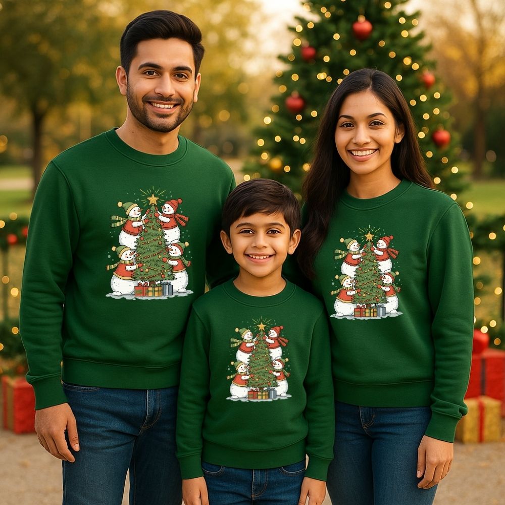 Family of three wearing matching Bottlegreen Christmas-themed sweatshirts 