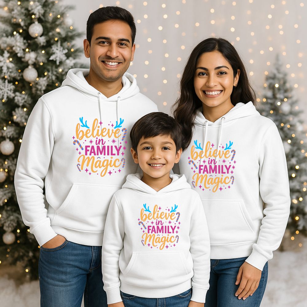 Family of three wearing white hoodies with 'believe in Family Magic' text