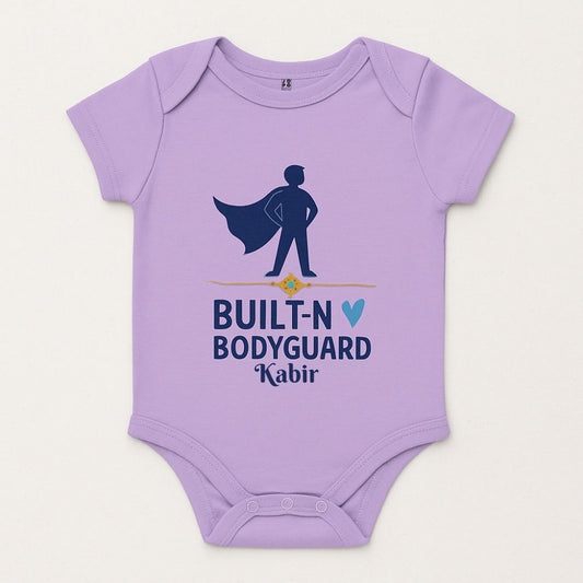 Lavender baby onesie with a superhero design and 'Built-N Bodyguard' text 