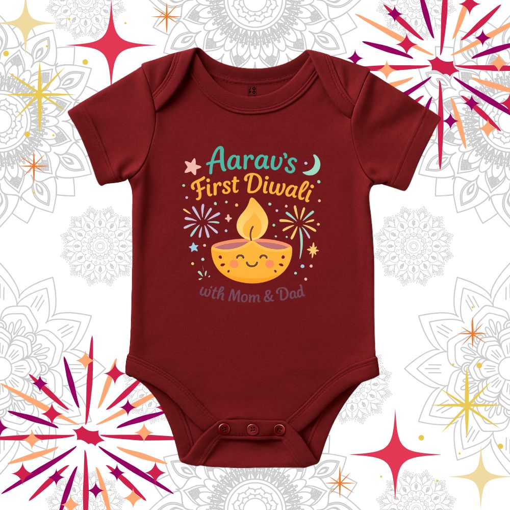 Maroon baby onesie with 'First Diwali with Mom & Dad' text and a smiling lamp design 