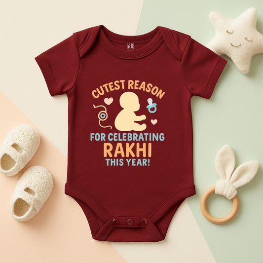 Maroon baby onesie with Rakhi-themed 'Cutest Reason, For Celebrating Rakhi This Year' text 