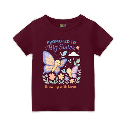 Maroon t-shirt with butterfly design and text 'Promoted to Big Sister Growing with Love' 