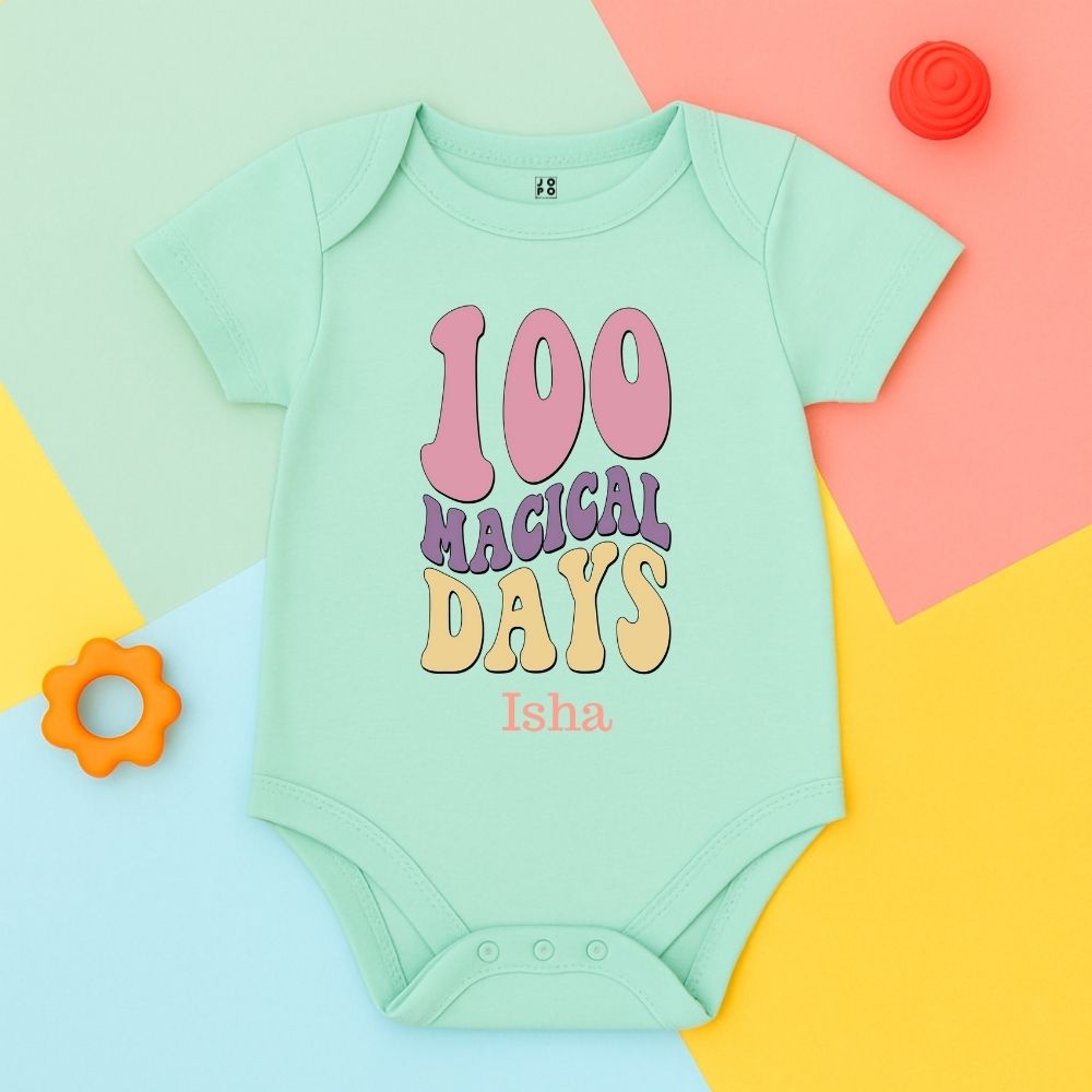 Mint green baby onesie with 100 Magical Days text