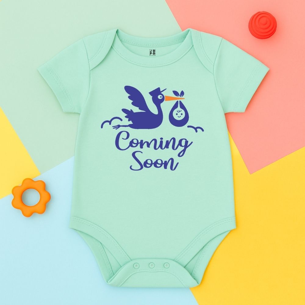 Mint green baby onesie with stork and 'Coming Soon' text