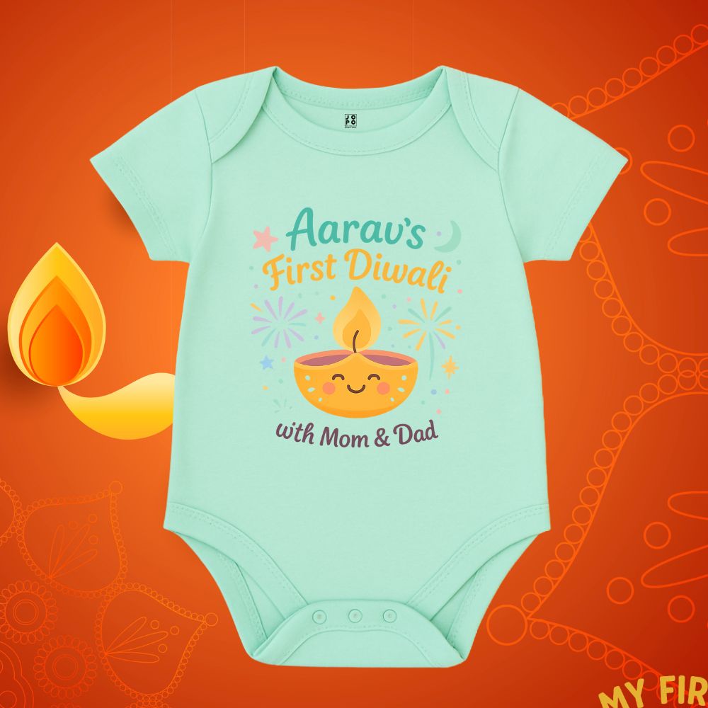 Mintgreen baby onesie with 'First Diwali with Mom & Dad' text and a smiling lamp design 