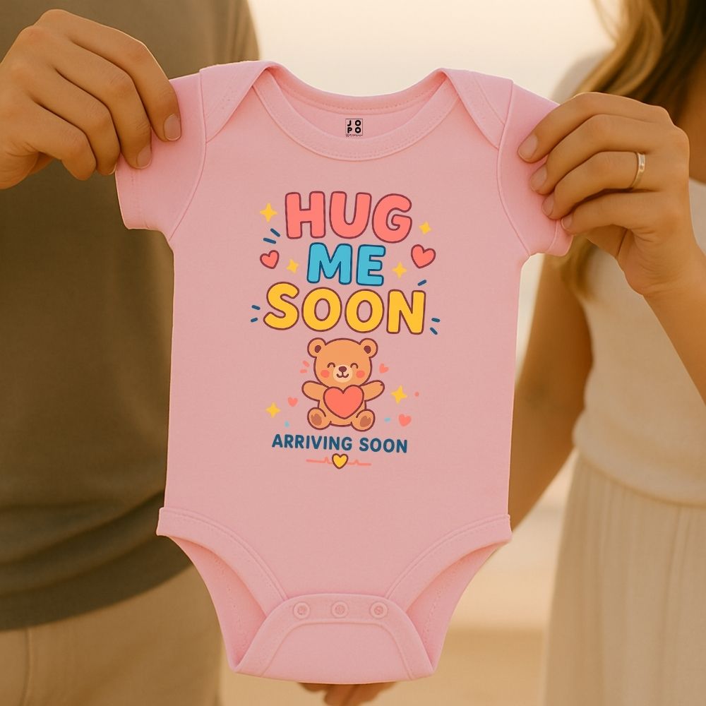 Pink baby onesie with 'Hug Me Soon' text and bear graphic 