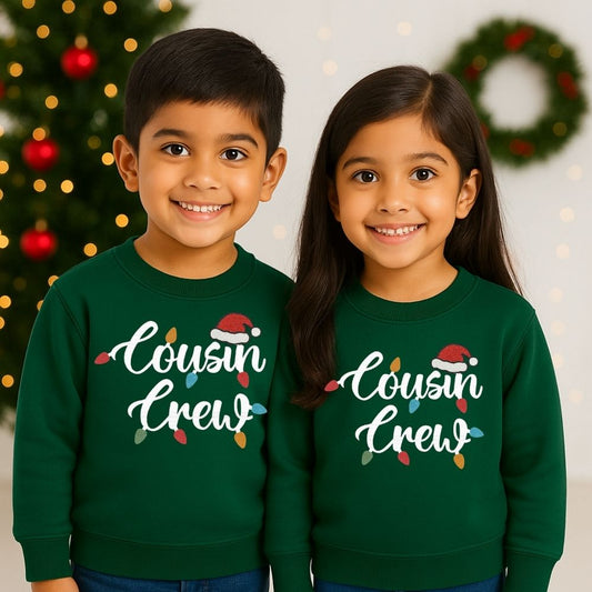 Two children wearing Bottlegreen 'Cousin Crew' sweatshirts with Christmas-themed text 