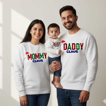 White Family of three wearing matching 'Mommy Claus', 'Baby Claus', and 'Daddy Claus' sweatshirts.