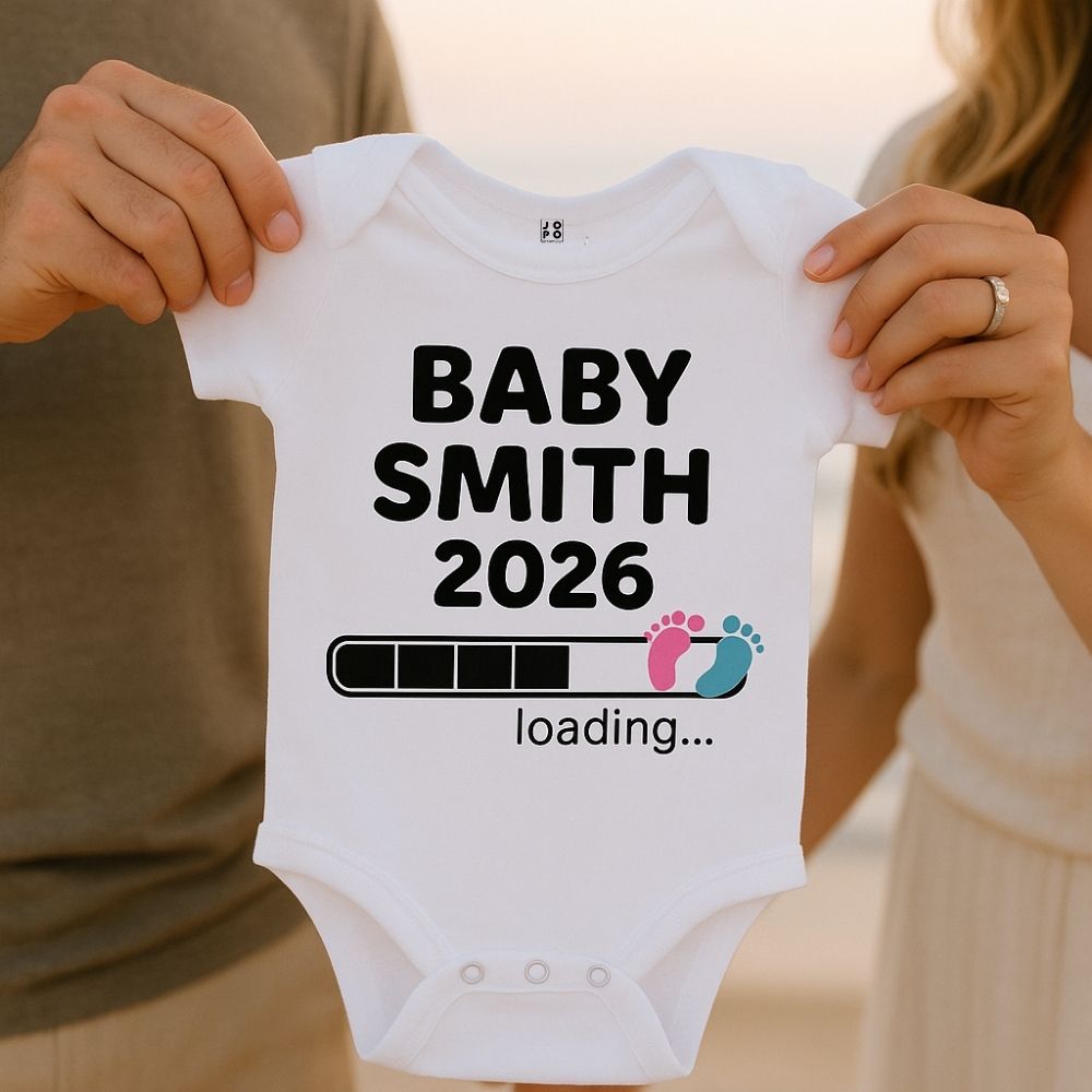 White baby onesie with 'BABY SMITH 2026 loading...' text and Baby Footprint with Loading Bar Graphic design