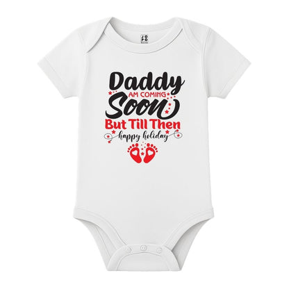 White baby onesie with text 'Daddy am coming soon but till then happy holiday' 