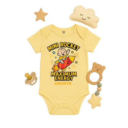 Yellow baby onesie with a rocket design and text 